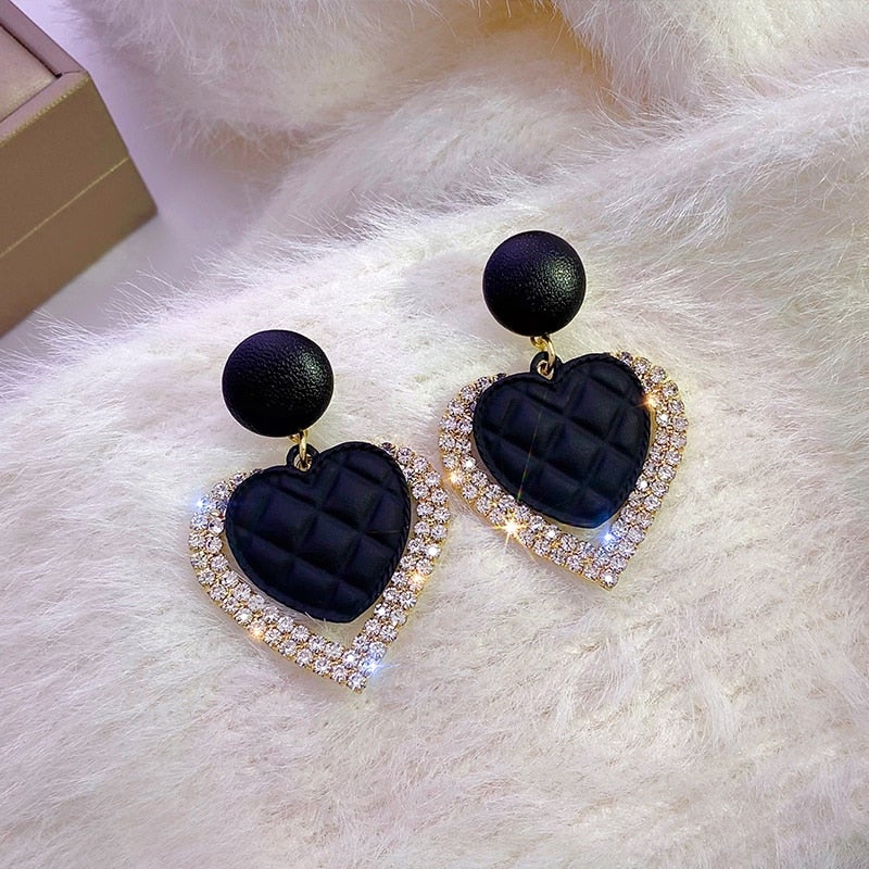 Black heart-shaped gold earrings